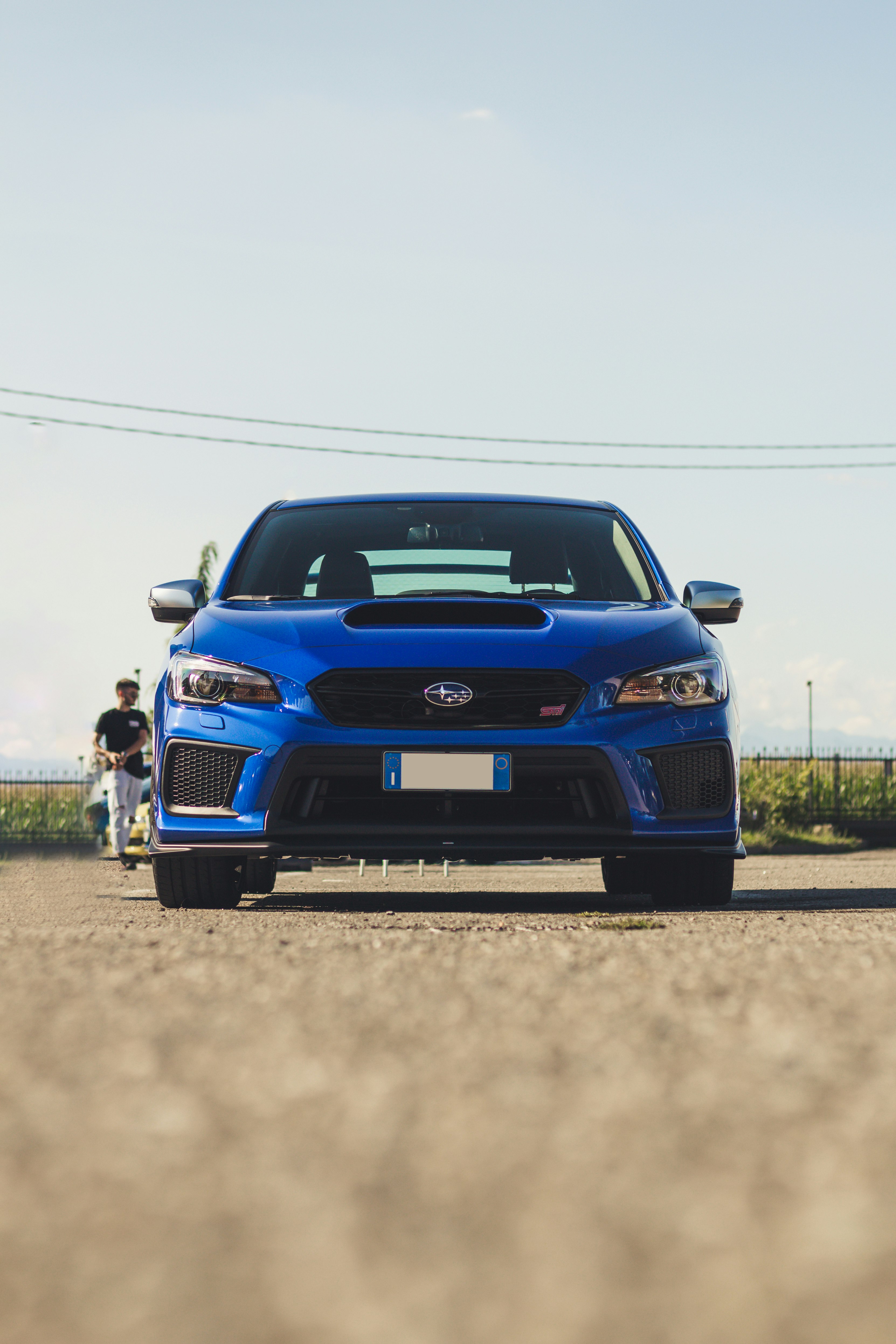 blue chevrolet camaro on road during daytime